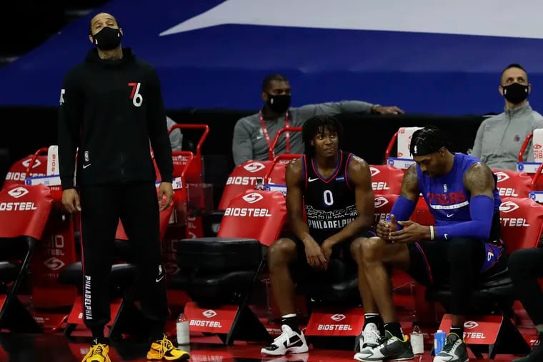 Injured forward Mike Scott, guard Tyrese Maxey, and center Dwight Howard sit on the bench against the Denver Nuggets during the fourth quarter on Saturday, January 9, 2021 in Philadelphia.  The Sixers had nine players who were not available due to injury or had  exposure to the coronavirus.