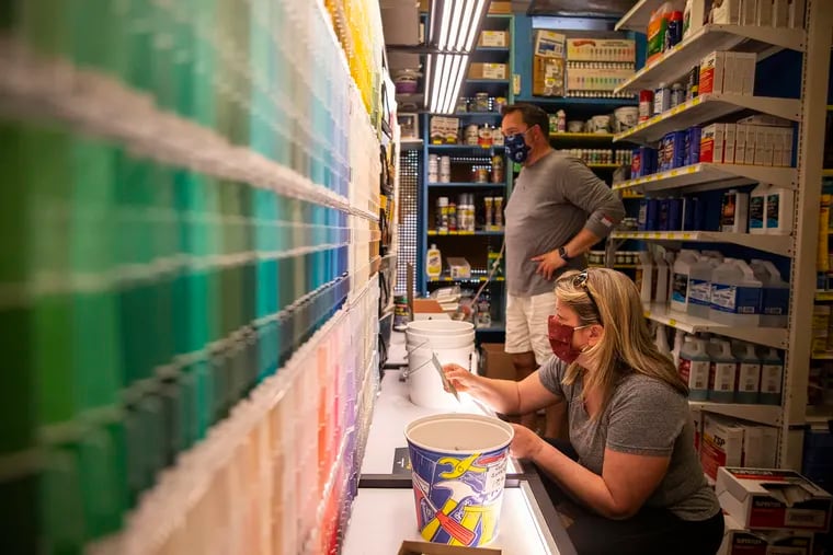 Christine White, and her husband, Trey White, of Erdenheim, Pa., look at the selection of paint colors for ideas for painting rooms and front door of their house at Kilian Hardware on Thursday, May 21, 2020. Pandemic home improvement projects have been through the roof.