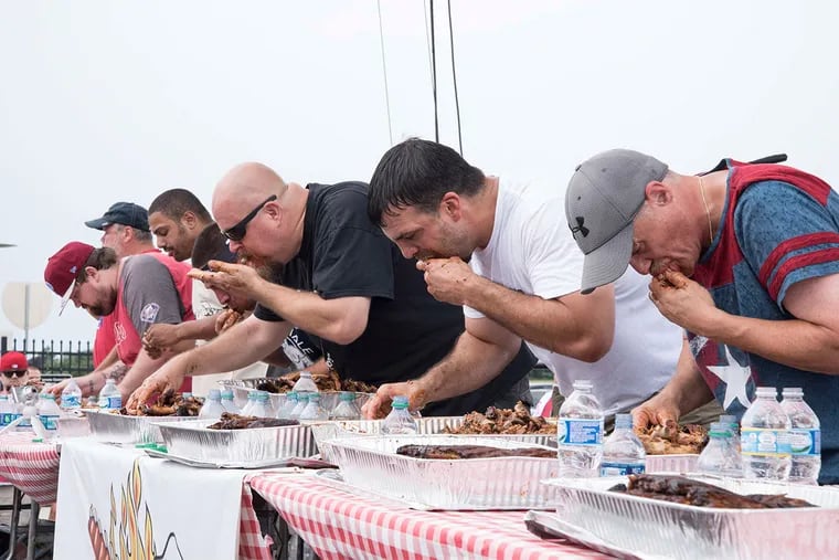 Contestants chow down during a rib-eating contest at Philly's BBQ Fest 2016 at Citizens Bank Park.