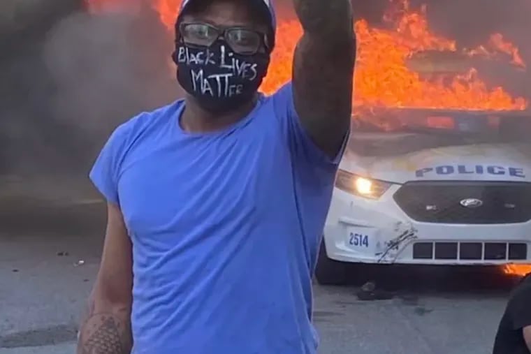 Khalif Miller shoots a selfie in front of a burning Philadelphia police car that prosecutors accused him of setting ablaze during racial justice protests in May 2020.