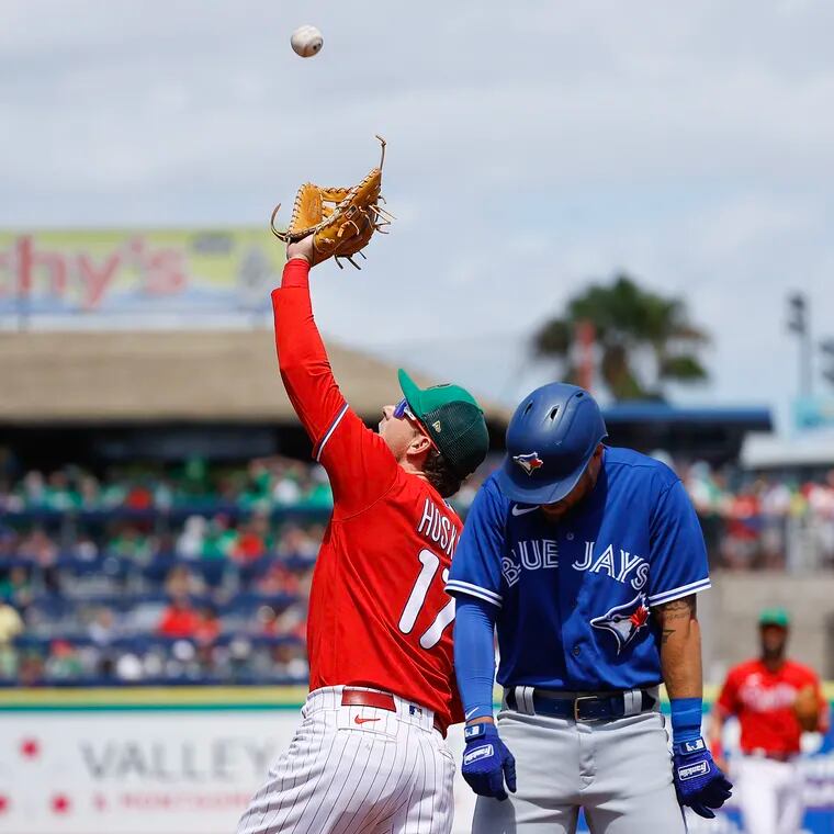 Phillies first baseman Rhys Hoskins watches the baseball into his glove on Blue Jays Rainer Nunez’s pop-up as Nathan Lukes moves away.