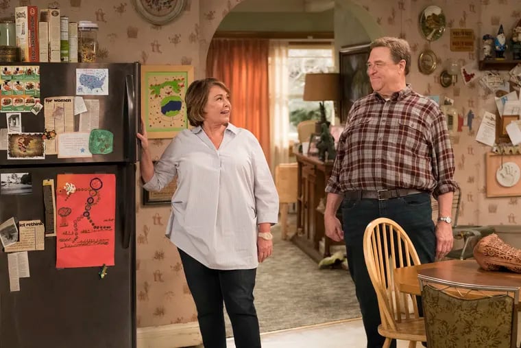 Roseanne Barr and John Goodman in a scene from the rebooted "Roseanne" on ABC. In the wake of the show's cancellation over a racist tweet by Barr, producers are working on a spinoff that she wouldn't be involved in
