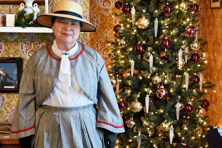 Kathy Smith, her her authentic 1860's reproduction dress, poses in the living room of the 1864 Edward Compton House.