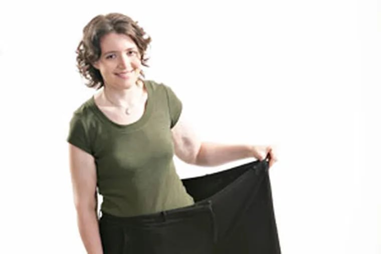 Author Jennette Fulda stands in one leg of the pants she wore before her diet.