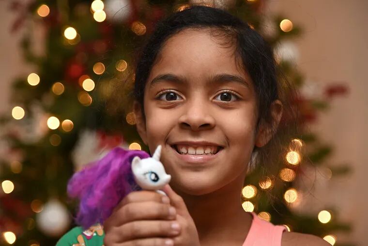 Ismarie Gomez, 8, poses with her favorite 'My Little Pony" December 6, 2017. Staying with her mom and relatives in South Philadelphia since Hurricane Maria forced them to leave their home in Puerto Rico, Ismarie, who was able to bring only a few of her toys, was ready to give away her favorite pony in a toy drive at school. TOM GRALISH / Staff Photographer