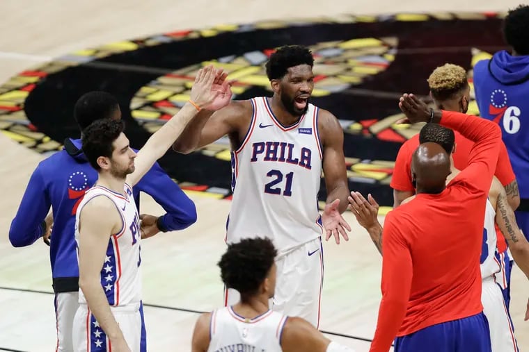 Sixers center Joel Embiid celebrates his team's Game 6 104-99 win over the Atlanta Hawks during the NBA Eastern Conference semifinals on Friday.