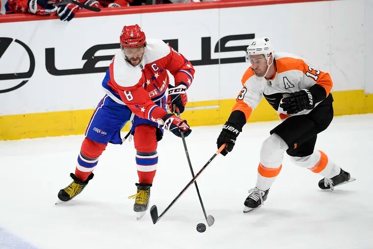 Washington Capitals left wing Alex Ovechkin (8) works for the puck next to Flyers center Kevin Hayes during the second period.