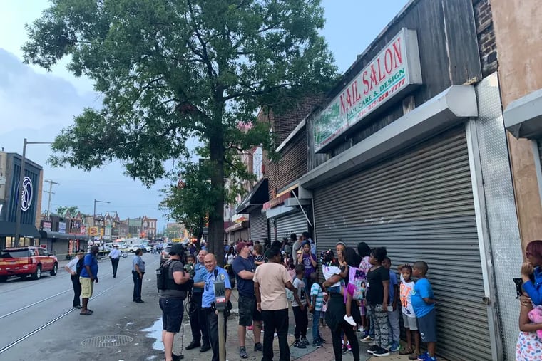 Police officers carried babies and mothers comforted shaken children as a day care on the block where the North Philadelphia shooting occurred was evacuated Wednesday evening.