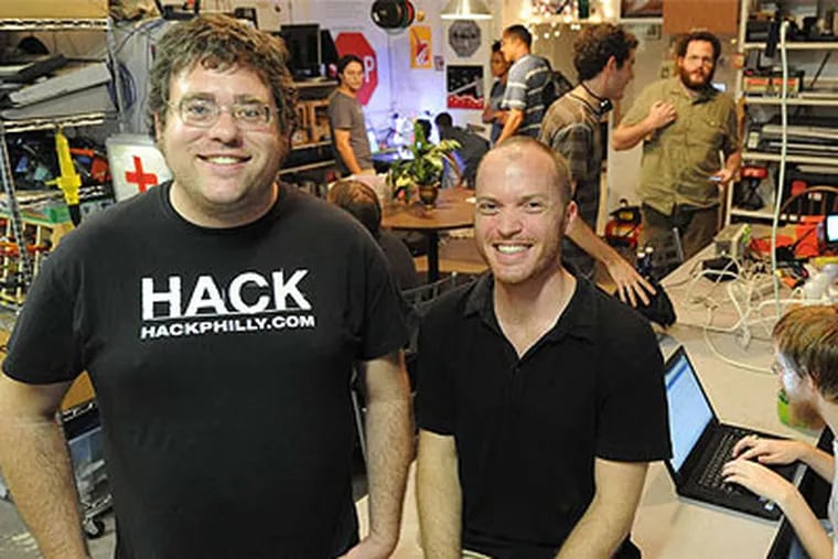 Chris Thompson and Jordan Miller (right) with fellow tinkerers at the hacker space Hive76 near Ninth and Spring Garden Streets. (Clem Murray / Staff Photographer)