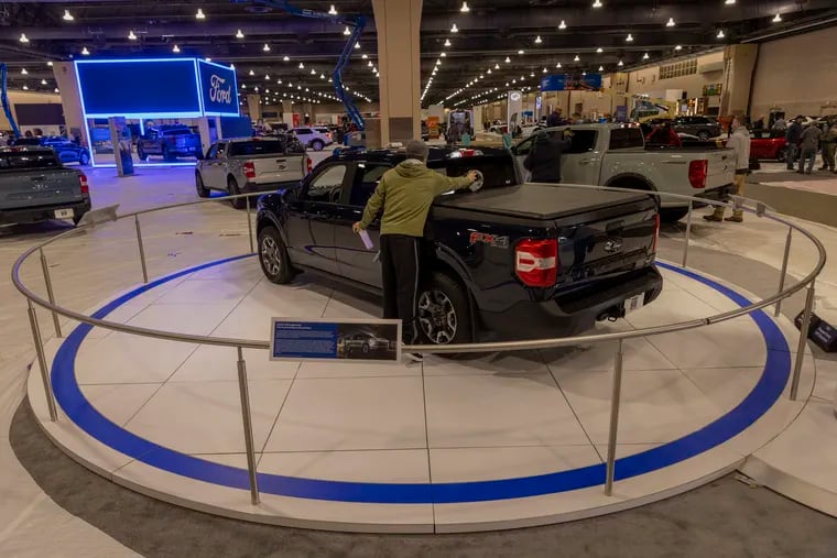 Workers in the Ford Motor Co. display wipe down vehicles as the 2022 Philadelphia Auto Show gets installed at the Pennsylvania Convention Center, 12th and Arch Streets, on Thursday afternoon March 3, 2022. The show opened on March 5.