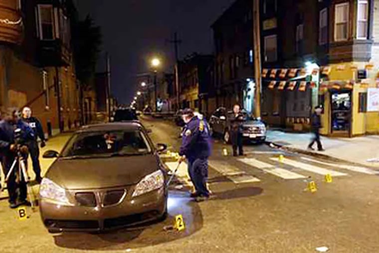 Police gather outside the Franchise Sports Bar at Broad & Somerset Streets in North Philadelphia on Sunday Nov. 18, 2007, to investigate a shooting where two people were shot to death. (For the Daily News/ Joseph Kaczmarek)