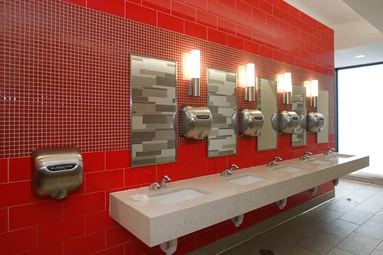 A new men's room at Philadelphia airport's Terminal B (below) with new sinks and lighting.