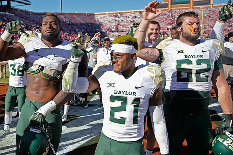 Baylor Bears defensive end Shawn Oakman (left) and safety Patrick Levels (21) and offensive lineman Tyler Edwards (62) celebrate after the game against the Oklahoma Sooners at Gaylord Family - Oklahoma Memorial Stadium. (Kevin Jairaj/USA Today)