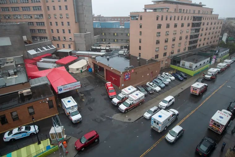 Ambulances are seen lined up outside the Elmhurst Hospital Center's Trauma Center entrance in Queens.