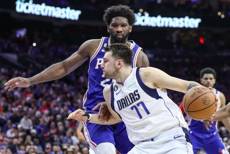 Philadelphia 76ers center Joel Embiid defends Dallas Mavericks guard Luka Doncic in the second half of a game at the Wells Fargo Center in Philadelphia on Wednesday, March 29, 2023.