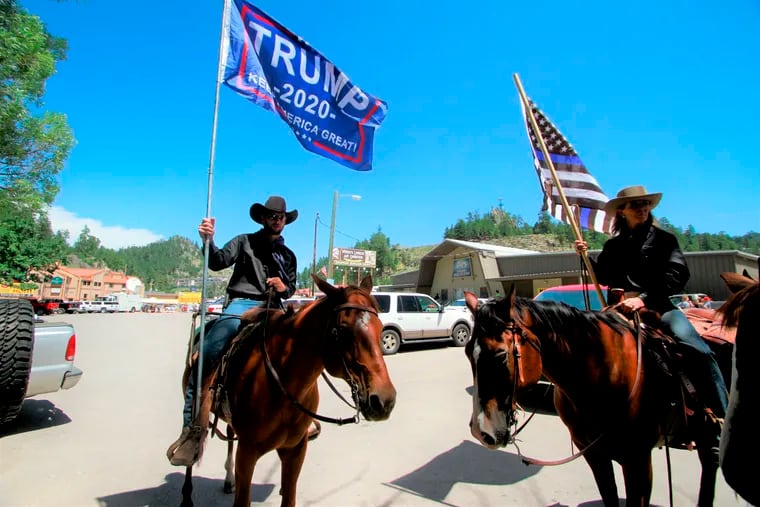 A group with Cowboys For Trump shows their support for the president in Keystone, S.D. on Friday, July 3, 2020.