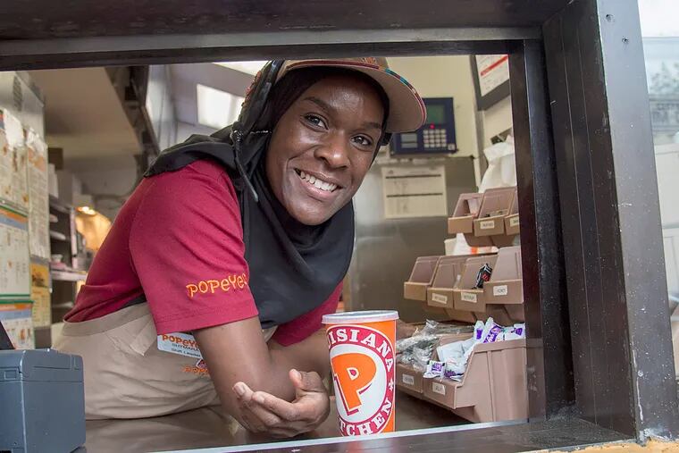 Shymara Jones, 23, is active in the Fight for 15 movement to get the minimum wage increased to $15 per hour, works the drive-thru window at the Popeyes on South Broad St.