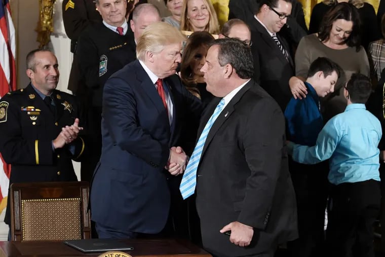President Donald Trump greets Gov. Christie at an event at the White House in October. The Trump administration on Wednesday appointed a Christie ally, Craig Carpenito, as interim U.S. Attorney for New Jersey.