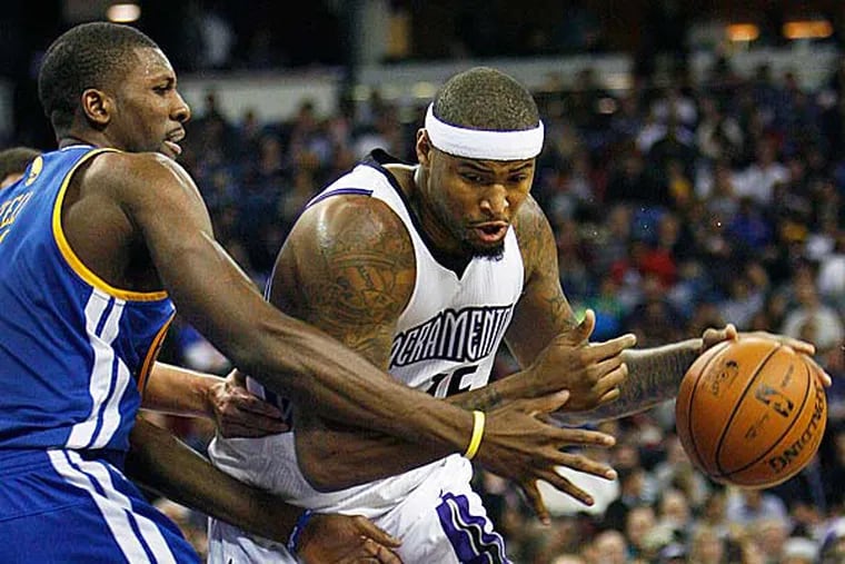 Sacramento Kings center DeMarcus Cousins, right, drives to the basket around Golden State Warriors defender Festus Ezeli during the second half of an NBA basketball game in Sacramento, Calif., on Wednesday, Dec. 19, 2012. The Kings won 131-127.(Steve Yeater/AP)