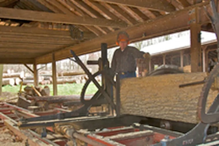 David Spacht in his sawmill. Spacht, who sells most of his sawdust to horse farms for bedding, says he has not raised his prices because he still feels fortunate to be able to get rid of it.