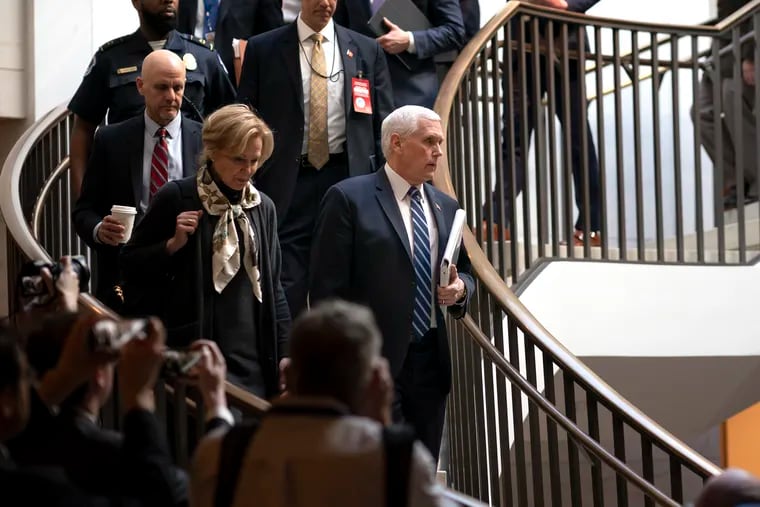 Vice President Mike Pence, center, joined at left by Dr. Deborah Birx, the coronavirus response coordinator, arrives at the Capitol to brief House members on the COVID-19 outbreak, in Washington, Wednesday, March 4, 2020. Congressional negotiators have reached agreement on an $8.3 billion bill to fund the government's response to the public health emergency.