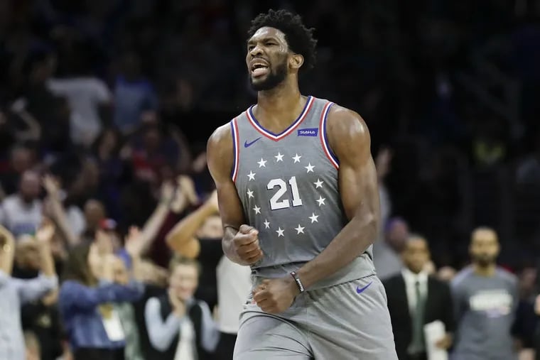 Sixers center Joel Embiid celebrates his late three-point basket that tied the game against the Charlotte Hornets on Friday, November 9, 2018 in Philadelphia.