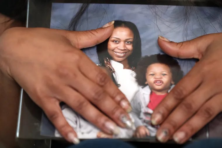 Dominique Lockwood, the mother of Abdul "Latif" Wilson, holds a photo of her and her son as she talks about his death.