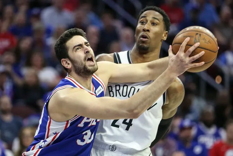 The Sixers' Furkan Korkmaz gets fouled by the Nets' Rondae Hollis-Jefferson during the fourth quarter.