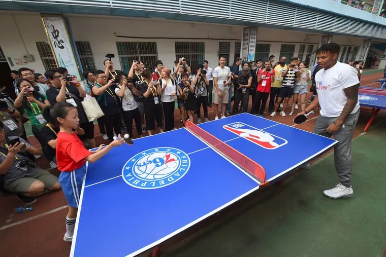 Markelle Fultz plays ping-pong with a student at a community service event at the Shenzhen Nanshan Lishan School in Shenzhen, China.