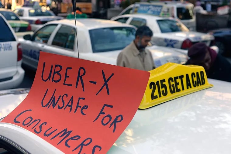 Drivers with the Taxi Workers Alliance of Pennsylvania protest on JFK Boulevard against Uber and Lyft in 2014.