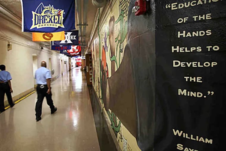 Officers walk the hallways of Sayre High in West Philly on Friday. (Alejandro A. Alvarez/Staff)