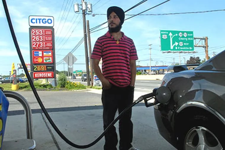 Harpreet Singh pumps gas for a customer at his uncle's Citgo gas station on southbound Route 130 in Pennsauken. The price was going to drop on Wednesday, but the owner decided to keep regular at $2.53 because prices were beginning to go up for the Memorial Day holiday weekend. (Tom Gralish / Staff Photographer)