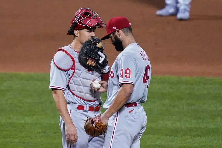 Phillies catcher J.T. Realmuto, left, holds a meeting on the mound with starter Jake Arrieta Friday night in New York.