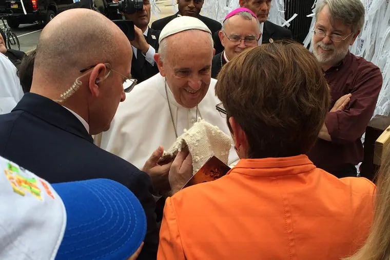 Sister Mary Scullion presents Pope Francis a stole knit with the prayer knots from prisoners, homeless and mentally ill as he visited the Knotted Grotto outside St. Peter's Basilica on Sept. 27,2015. ( Mari A. Schaefer / Staff )