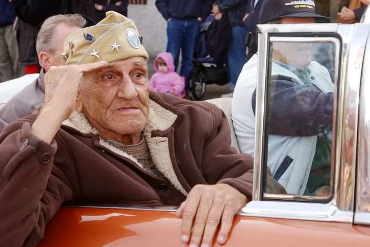 During the 2004 Veterans Day parade in Media, William Guarnere salutes. Guarnere, who owned a rowhouse on Winton Street in South Philadelphia, died this year at 90. Now the home will be going to another disabled veteran.