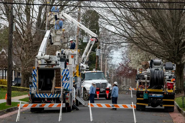Peco crews work on restoring power along Washington Avenue in Newtown, Bucks  County, after the April 1 tornado outbreak. No twisters were reported Saturday, but some places got hit hard by storms.
