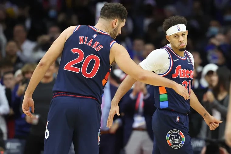 Seth Curry, right, of the Sixers is congratulated by Georges Niang after hitting a clutch shot late in the game against the Bulls at the Wells Fargo Center on Nov. 3, 2021.