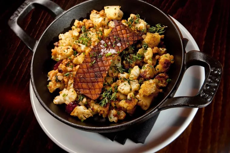 Spiced cauliflower with royal trumpet steak, dried fruit and pine nuts as served at Charlie Was a Sinner. (DAVID M WARREN / Staff Photographer)