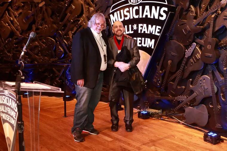 Musicians Hall of Fame director Joe Chambers (left) joins Bobby Eli at the induction ceremony.