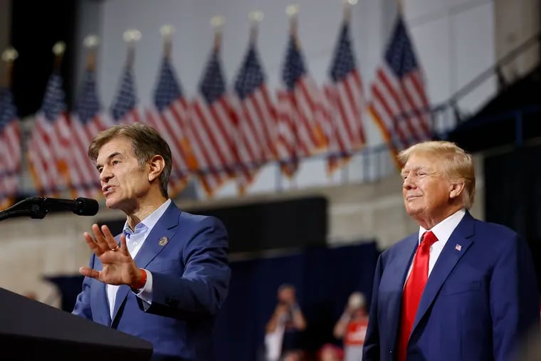 Former President Donald Trump listens to Mehmet Oz speak at a rally in Wilkes-Barre in early September.