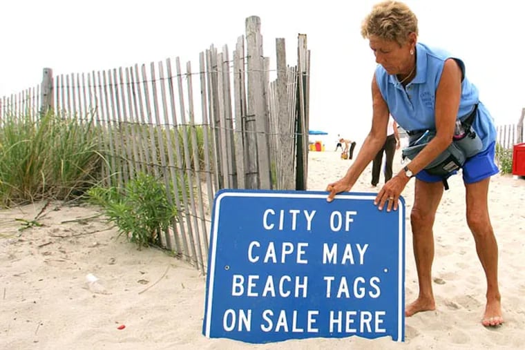 Jackie Rotz puts her Beach Tag sign outside her gate where she sells and validates beach tags in Cape May, N.J. on Monday, July 18, 2005. Rotz is famously vigilant for checking and enforcing beach tags, even going blanket to blanket to make sure those who hit the sand before she got on duty have tags. (AP Photo/Tim Larsen)