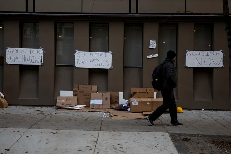 A man passes by the Center City Holiday Inn in December 2020, as city officials prepared to move its residents -- homeless Philadelphians with nowhere else to quarantine -- into other accommodations.