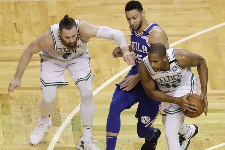 Sixers’ guard Ben Simmons loses a battle for the ball to Celtics bigs Al Horford (right) and Aron Baynes during the Sixers’ Game 2 loss.