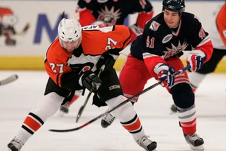 Flyers left winger Dmitry Afanasenkov (left) fends off an attempt by the Rangers&#0039; Jed Ortmeyer to steal the puck. Afanasenkov is looking to stay in Philadelphia. The Flyers have qualified him.