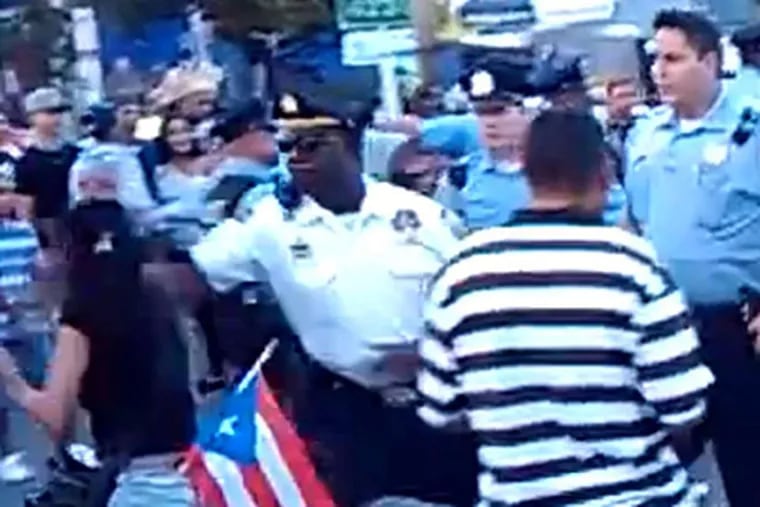A still taken from video during Sunday's Puerto Rican Day celebration shows Lt. Jonathan Josey striking Aida Guzman, 39, of Chester.
