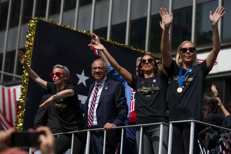 From left, Megan Rapinoe, U.S. Soccer Federation President Carlos Cordeiro, Alex Morgan, and Allie Long wave to the crowd as they makes their way down the Canyon of Heroes in lower Manhattan for their World Cup championship parade on Wednesday, July 10, 2019.