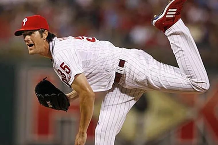 Cole Hamels delivers a pitch during the Phillies 22-1 rout of the Reds on Monday. Hamels pitched seven innings and even went 2-for-4 at the plate, with two runs scored and two RBIs. (Ron Cortes / Staff Photographer)
