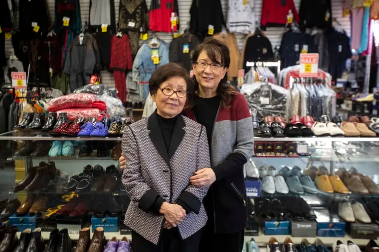 Owners Jae C. Kim and her daughter Jenny Kim pose for a portrait at Kim's Clothing store in the Germantown neighborhood in Philadelphia, Pa. on Thursday, March 5, 2020.  The store is closing after being open for 40 years.