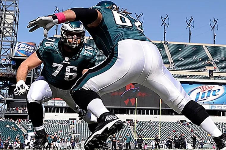 Eagles center Jason Kelce works on his blocking with tackle Allen Barbre. (Michael Perez/AP)