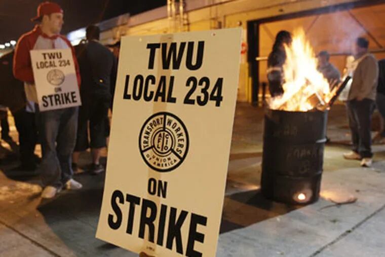 Striking SEPTA workers keep warm by a fire behind the SEPTA depot on Penn St. just behind the Frankford Transportation Center shortly after walking off the job at 3 a.m. on Nov. 3, 2009. (Elizabeth Robertson / Staff Photographer)